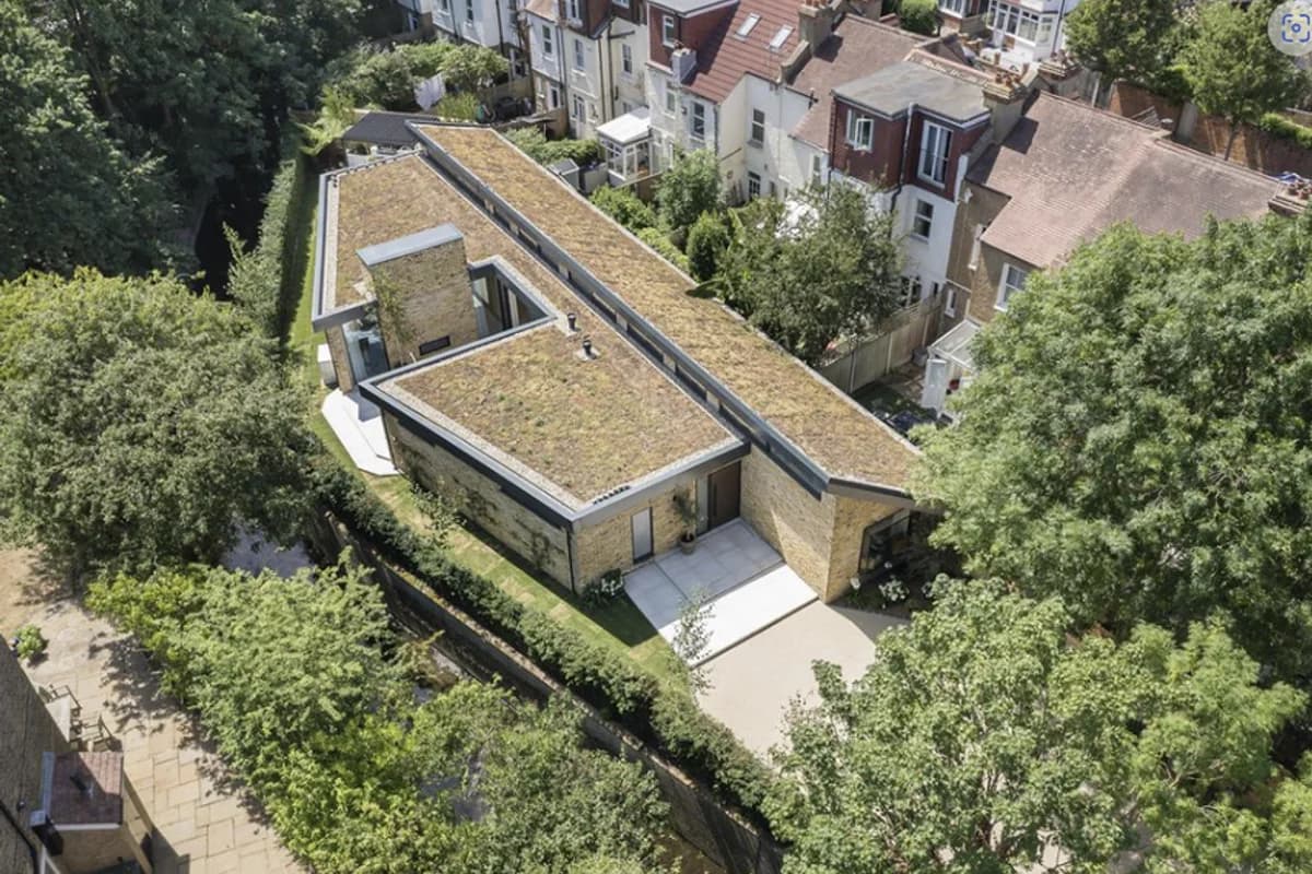 Aerial view showing the green roof and compact residential site.